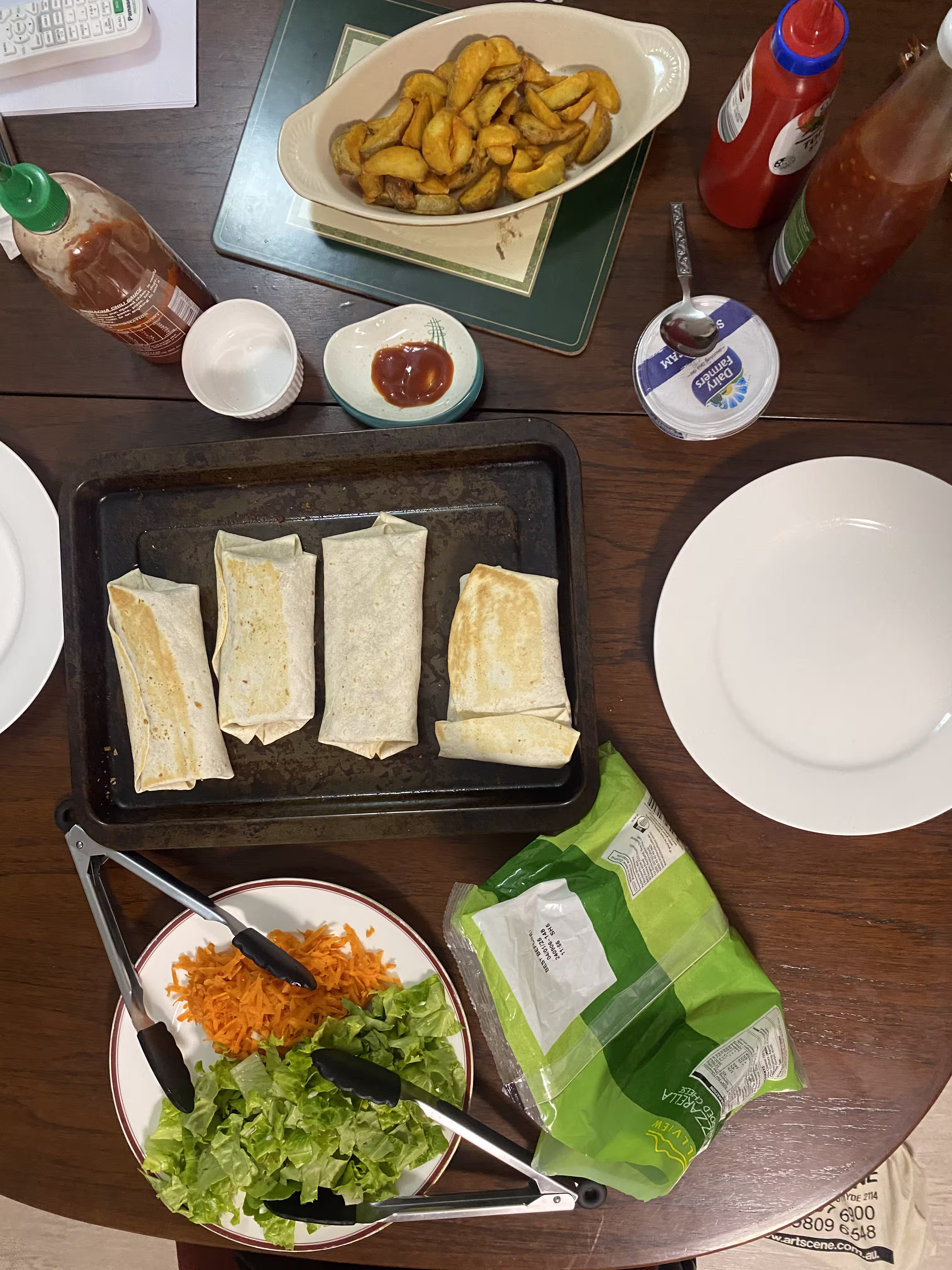 Burritos laid out with toppings